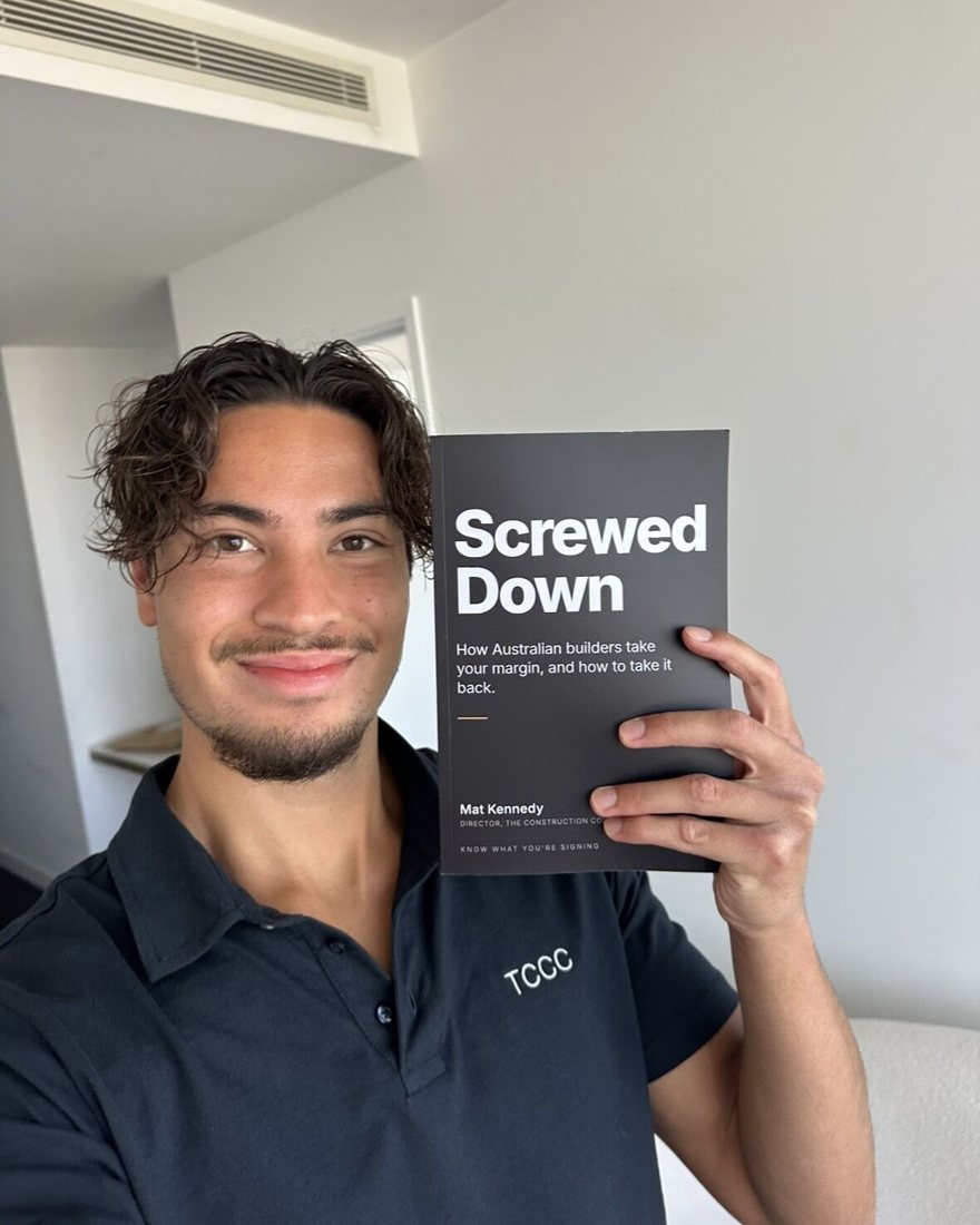 Mat Kennedy holding a copy of Screwed Down